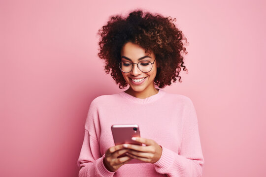 woman with phone on pink background.
