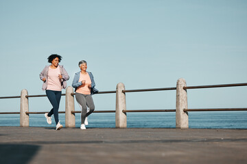 Senior, fitness and women friends at the beach for running, bond and morning cardio in nature...
