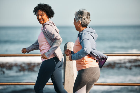 Fitness, Running And Senior Women By Ocean For Healthy Lifestyle, Wellness And Cardio On Promenade. Sports, Friends And Happy Female People Walking On Boardwalk For Exercise, Training And Workout