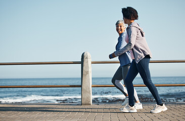 Women, beach and friends running for fitness together as morning exercise for wellness and outdoor bonding. Health, endurance and people training for marathon in Cape Town for sports workout © aLListar/peopleimages.com