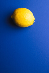 Close up of lemon and copy space on blue background