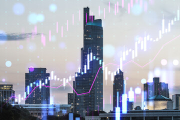Fototapeta na wymiar Creative glowing candlestick forex chart on blurry city buildings wallpaper. Technology, trade and financial data concept. Double exposure.