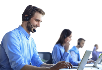 Smiling male call-center operator with headphones sitting at modern office with collegues on the backgroung, consulting online.