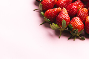 Close up of strawberries and copy space on pink background
