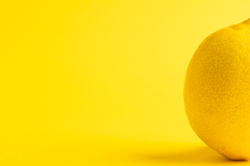 Close up of lemon and copy space on yellow background