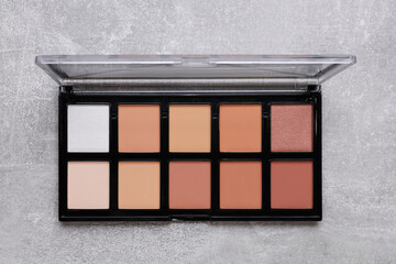 Contouring palette on light gray background, top view. Professional cosmetic product