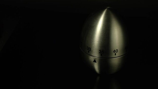 Time lapse of a kitchen clock timer countdown to zero.