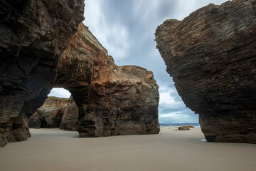 Playa de las Catedrales, Lugo, Galicia, Spain, on a cloudy day at sunrise