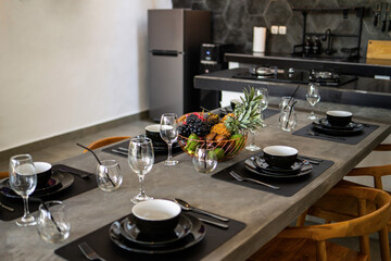 kitchen concrete table with gas stove. Dining room with living room overlooking the pool in the garden. Holiday concept