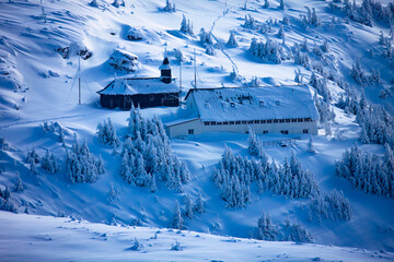 Fototapeta na wymiar Church in Winter Mountain Landscape. Ceahlau, Romania