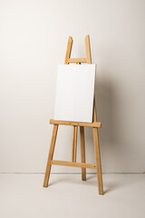 White canvas on wooden easel and copy space on white background
