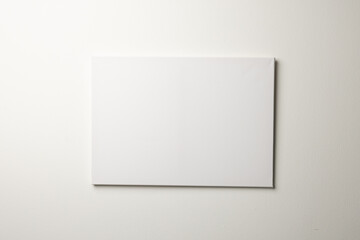 White canvas and copy space hanging in white wall background