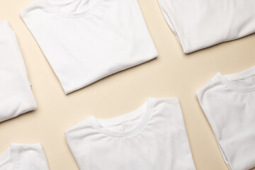 Close up of folded white t shirts and copy space on yellow background