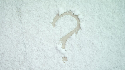 Question mark painted on white snow closeup. Finding a solution and uncertainty