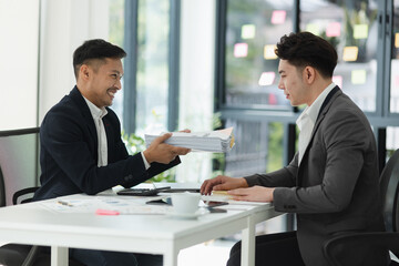 Teaching and showing mistakes to new trainee at office desk, supervisor giving instructions,
