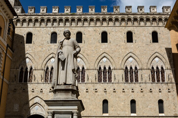 SIENA, ITALY - MAY 11, 2023: Palazzo Salimbeni palace, the Main Office or Headquarter of Monte dei Paschi Bank, with Statue of Sallustio Bandini