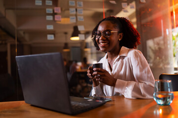 Black businesswoman working on laptop. Portrait of beautiful businesswoman in the office.