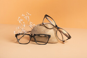 Nature stone with eyeglasses on colored background. Optical store, vision test, stylish glasses...