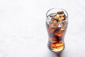 Refreshing glass of cola with ice