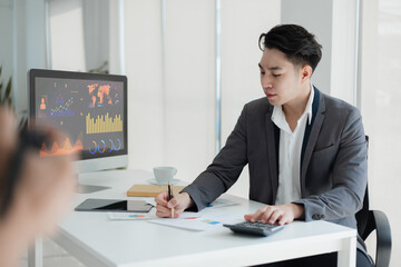Technology and financial advisory services concert. Businessman working on digital laptop computer with advisor showing plan of investment to clients at table office. Digital marketing, Stock market.