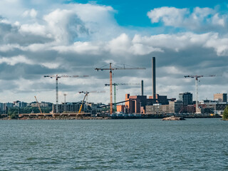 Fototapeta na wymiar Helsinki, Finland - 07 04 2023: General view of the city and construction cranes. Construction of new facilities in the center of Helsinki
