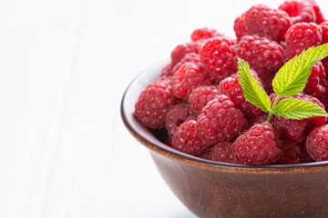 Raspberry in a basket .on wooden background