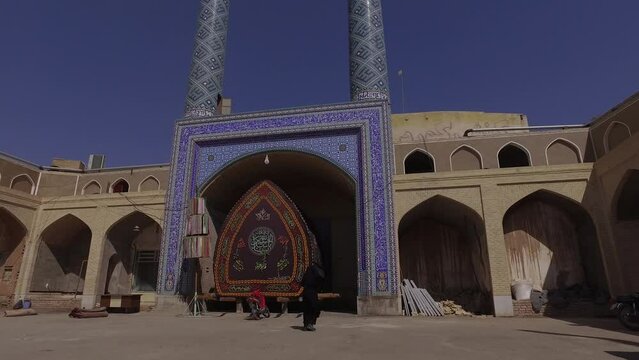 A nakhl and an alam in front of a mosque Yazd Iran