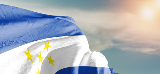 Honduras national flag cloth fabric waving on beautiful sky Background.