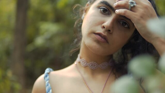 Cinematic focus shift to the face of a fashion model in the tropical rain forest of Goa in India, Slomo, Slow-Motion
