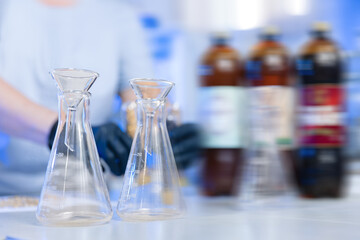Laboratory assistant inspecting production beer, analysis drink in glasses. Concept brewery food industry