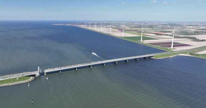 Drone view on the Ketelbrug with the A6 highway. In the background are one of the biggest windturbines. The bridge is located between the Ketelmeer and Ijsselmeer in Flevoland, The Netherlands