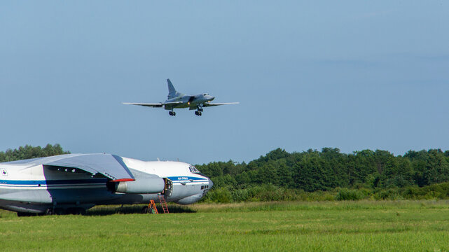  In foreground, Il-76MD aircraft. Close-up. Tu-2M3 (NATO - Backfire) bomber-carrier performs a demonstration flight. VillageTown, Russia, June 15, 2012