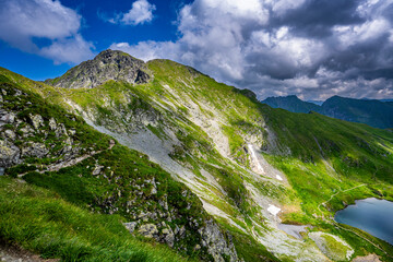 Naklejka na ściany i meble Mount Vanatarea lui Buteanu. Summer landscape of the Fagaras Mountains, Romania. A view from the hiking trail near the Balea Lake and the Transfagarasan Road.