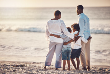 Black family, hug at beach travel and together watching ocean waves and sunset view, freedom with parents and kids. Man, woman and children outdoor, vacation in Bali, nature and peace with back © Bettencourt/peopleimages.com