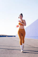 vertical photo with motion of a caucasian sportswoman running in a athletic track, concept of sport...