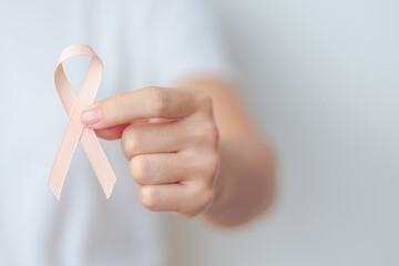 woman holding Peach Ribbon for September Uterine Cancer Awareness month. Uterus and Ovaries,...