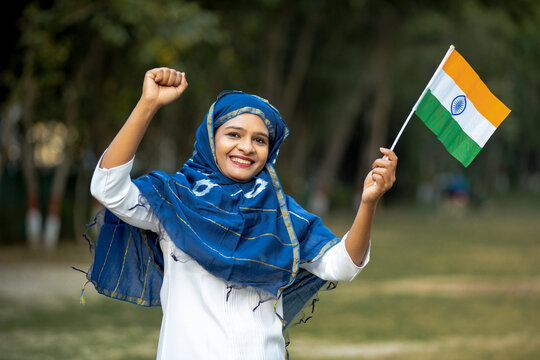 Indian woman waving tricolor flag and celebrate national festival.