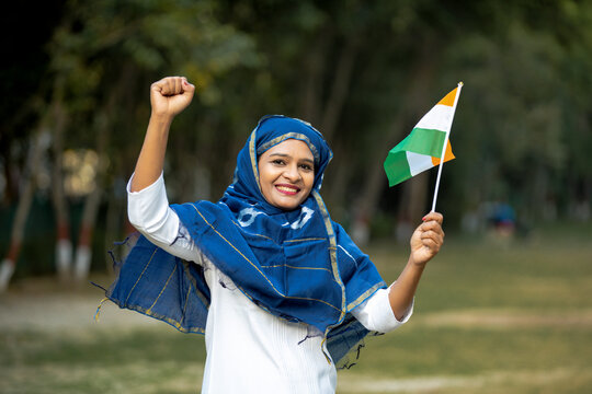 Indian woman waving tricolor flag and celebrate national festival.