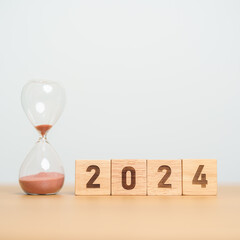 2024 text with hourglass on table. Resolution, time, plan, goal, motivation, reboot, countdown  and New Year holiday concepts