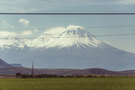 View of Mount Hasandagi, a Mountain Peak and inactive volcano with snow on the top in wintertime, Aksaray, Turkey.