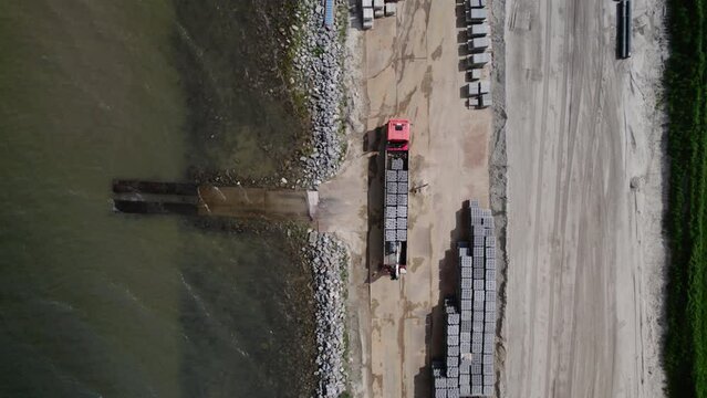 AERIAL MS Construction materials on Wadden Sea shore, Friesland, Netherlands
