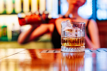 woman hand bartender making negroni cocktail in bar