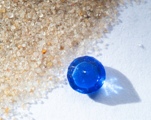 sapphire crystal in the sand.