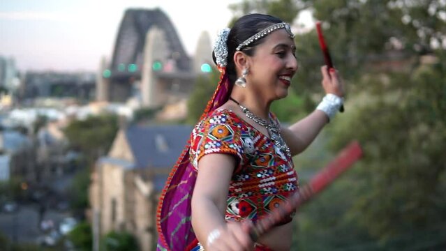 South Asian Woman Performing Indian Classical Dance In A Garden In Australia - medium