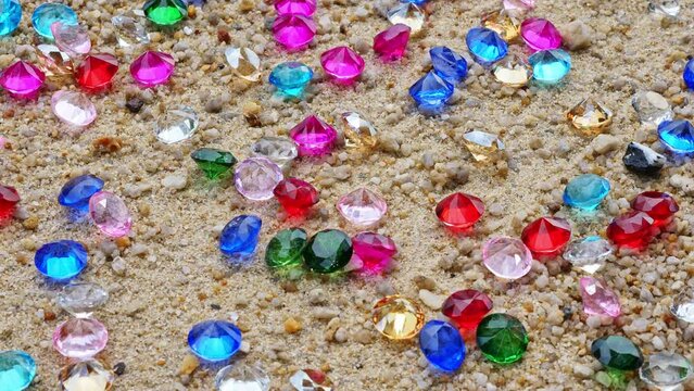 .Colorful diamonds on the beach..Each diamond caught the glimmer of the sun, glistening in the sand..The sparkles of the diamonds lit up the shoreline, creating a mesmerizing landscape..