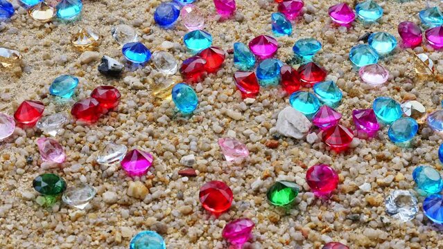 .Colorful diamonds on the beach..Each diamond caught the glimmer of the sun, glistening in the sand..The sparkles of the diamonds lit up the shoreline, creating a mesmerizing landscape..