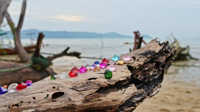 .Colorful diamonds on the timber The diamonds illuminated the wood, .catching the eye of anyone who admire their beauty..Colorful diamonds glisten background.