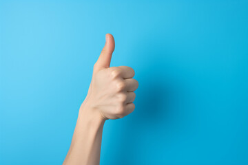 Thumb up. Hand showing thumb up, ok, agreement isolated on blue background. High quality photo