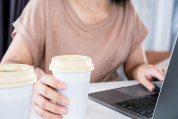 woman addicted to coffee, too much caffeine and drinking cups of coffee while working at office desk