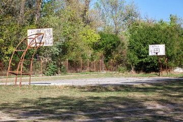 Old abandoned school sports court or schoolyard for basketball.